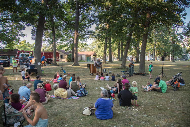Creston residents enjoy a neighborhood picnic and puppet show. 
