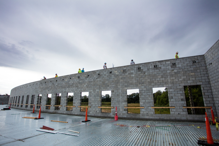 Workers build the walls and superstructure of the new school. 