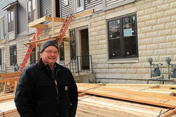 Jubilee Ministries Executive Director Steve Grose stands in front of a mixed-income housing project in Holland. (Photo by Andrea Goodell)