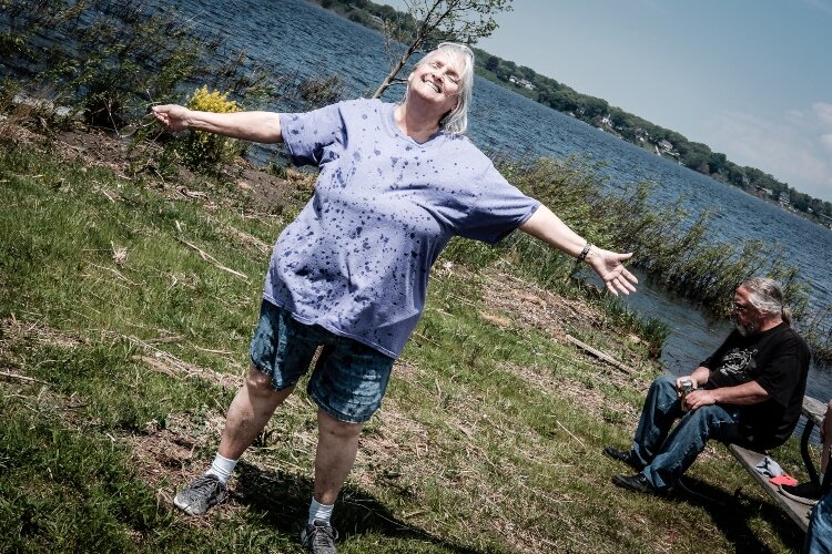 A Lemonade Stand member basks in the sun after playing in Muskegon lake. Group trips help to create shared experiences, building relationships among members. 