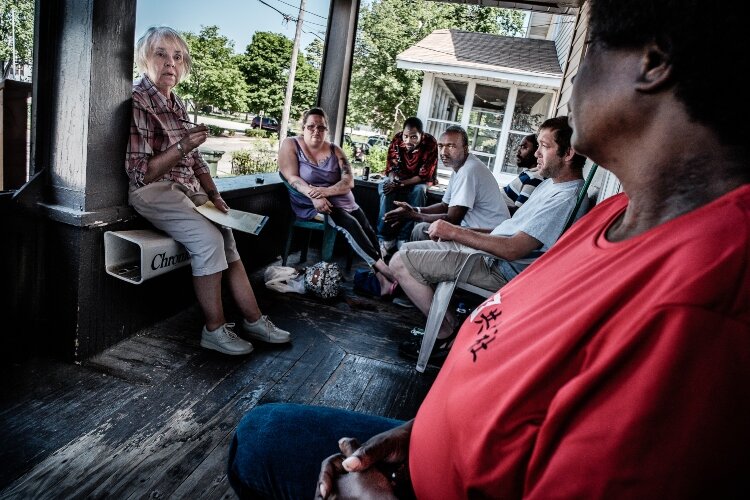 Judy leads a weekly Lemonade Stand members meeting. The stand is a member-run club where members hold positions, elections, and vote on measures when needed. 