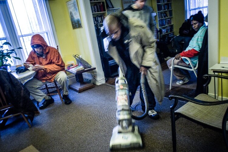 A Lemonade Stand Member performs their daily task of vacumming. All members are expected to share in the responsibilities of keeping the Stand clean and tidy.