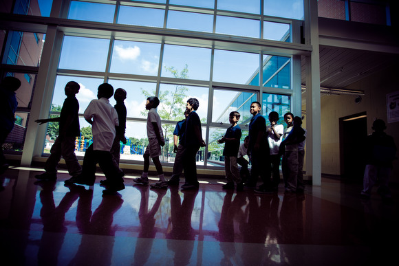 Kids line up while moving from the media center to the classroom at Dickinson elementary school.