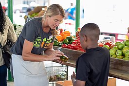 Amy St. Germain, a nutrition educator at the YMCA of Greater Grand Rapids, works as a Farmers Market Food Navigator at the Muskegon Farmers Market.