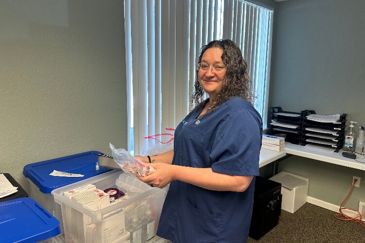 DocGo's Amanda McMann packs supplies for an in-home COVID vaccination visit. 