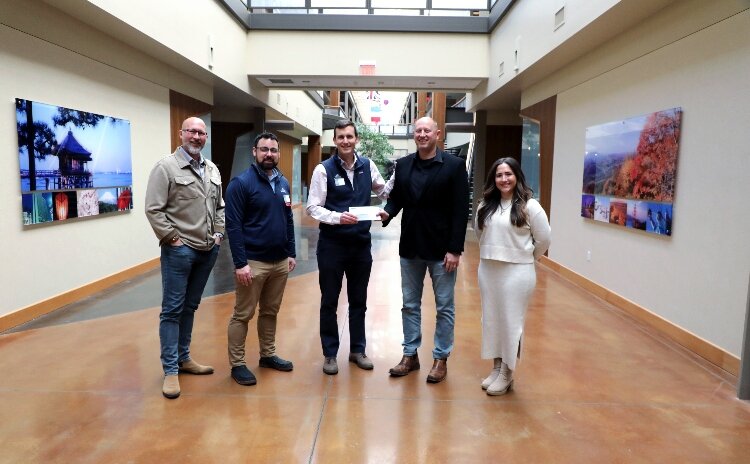 Gentex presents a donation check to Community Action House.