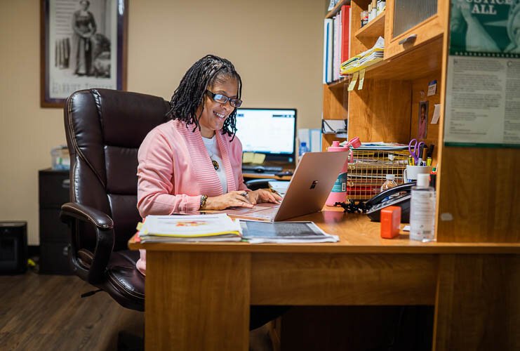 Zina Davis works in her office at Children of the Rising Sun