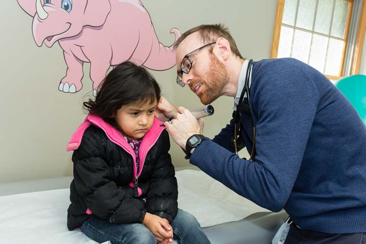 Daniel J. Ebenhoeh sees a young patient at Holy Family Healthcare.