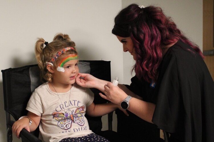 A child's face is painted at the D&HHS event. (D&HHS)