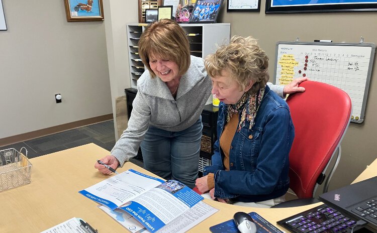 Barb Olsen, an event and volunteer specialist with Disability Network West Michigan, works with a volunteer at the organization.