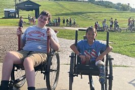 Two GRIT wheelchair users pose at a local park.