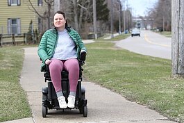 Elizabeth Ferry, of Holland, rides her motorized wheelchair on the sidewalk along Howard Avenue in Holland Township.