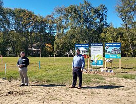 Jubilee Ministries Executive Director Steve Grose and Lakeshore Habitat for Humanity Executive Director Don Wilkinson speak to a crowd before a ceremonial groundbreaking at Park Vista Place on East 40th Street in Holland.