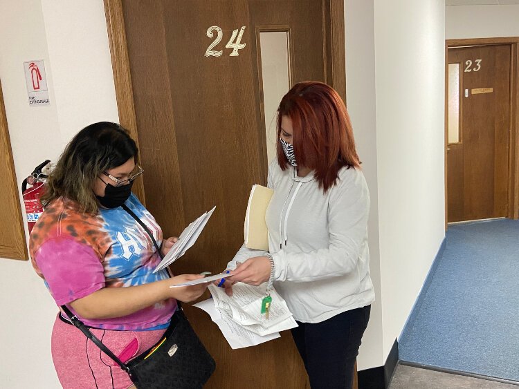 Good Samaritan Ministries is administering the MSHDA COVID-19 eviction diversion program. Pictured is Good Sam team member Virgenmina Calo (right) helping a client.