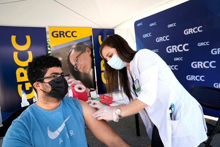 A student receives a shot at GRCC pop-up vaccination clinic.
