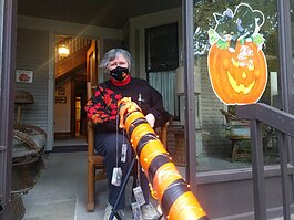 Carol Myers shows off the socially distanced, but festive Halloween tube at her 12th Street Holland home.