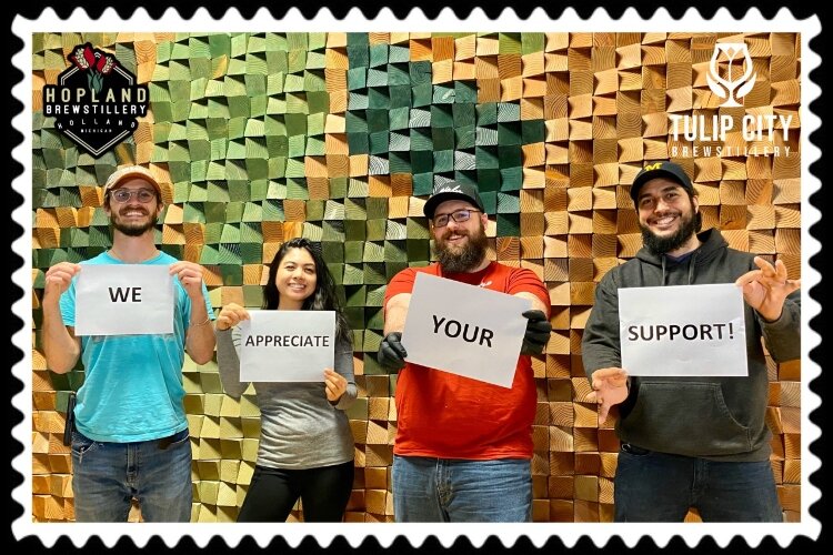 Holding the signs (l to r) are Ryan Johnson, Hopland Head Brewer/Owner; Melissa Andaya, Manager; Chris Crothers, Tulip City Head Brewer/Owner and Rick Moralez, Owner/Managing Member.