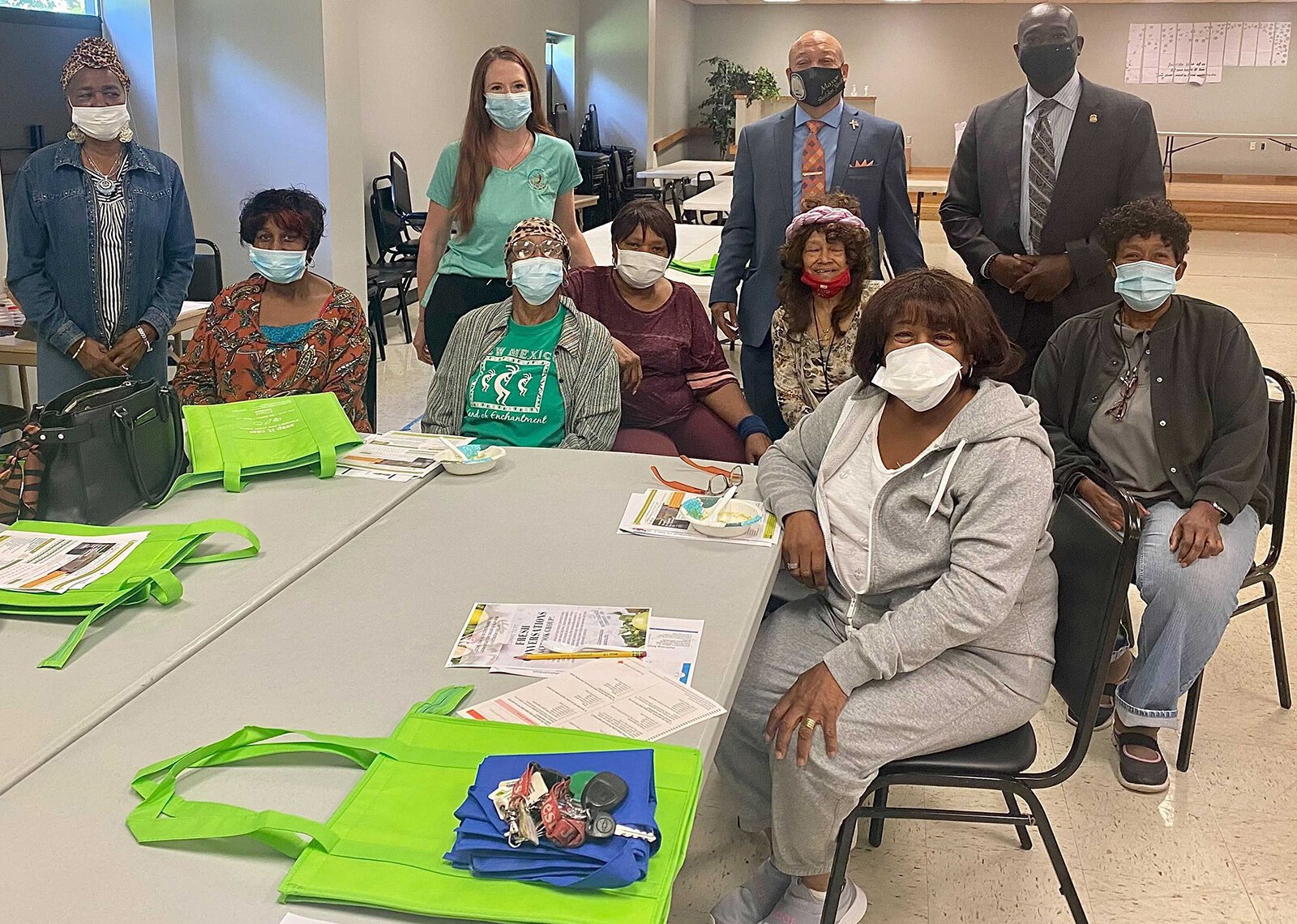 Flint Mayor Sheldon Neeley (in red tie) joins SNAP-Ed Nutrition Educator Amanda Mattila and residents during a Fresh Conversations session at Hasselbring Senior Center in Flint.