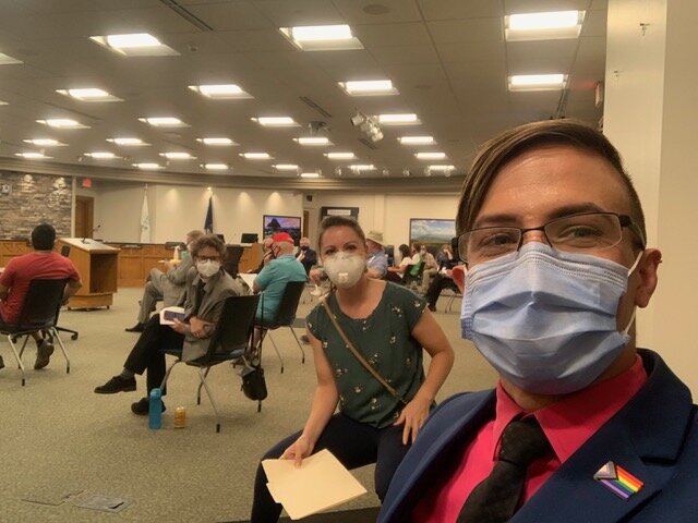 Jeffrey Sorensen, the Rev. Jennifer Adams, and Sara Van Tongeren pose in the Holland City Council chambers during a meeting to discuss a civil rights ordinance Aug. 19.