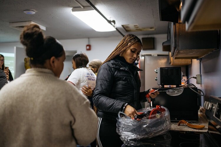 A TAC member checks out new kitchen utensils at the Vault.