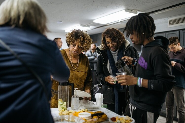 Supporters grab some food at the opening of the Vault's new kitchen.