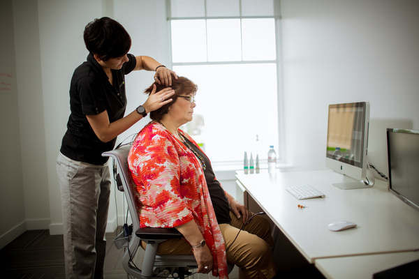 Lead Technician Emily Quinn connects Deborah Johnson Wood to the computer for biofeedback