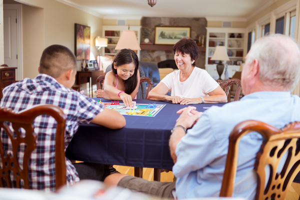Javier and Jessica play Sorry! with Beverly and Gary in their Holland home.