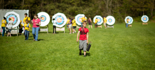 After shooting, all of the archers retrieve their arrows.