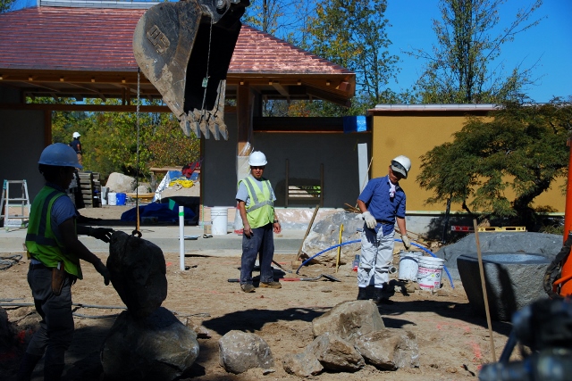 Hoichi Kurisu (in blue) places boulders with his crew