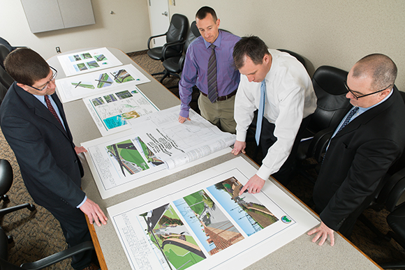 The team responsible at the City of Walker for the tunnel review the designs and discuss details.
