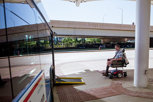 David Covey takes the ramp onto one of the Rapid's buses. 