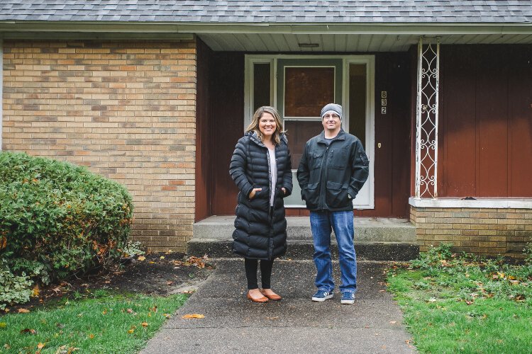 Michigan Fosters Executive Director Tiffany Kraker and Holland Heights CRC Parsonage Committee Chairman Kevin Anderson stand outside of what is soon to become Journey Home, a place for families navigating foster care.