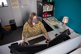 Joyanne Huston-Swanson, community relations for the Kent District Library, works with a wi-fi hotspot that is available for checkout at the library. Patrons have used the hotspots to access telehealth appointments, among other needs.