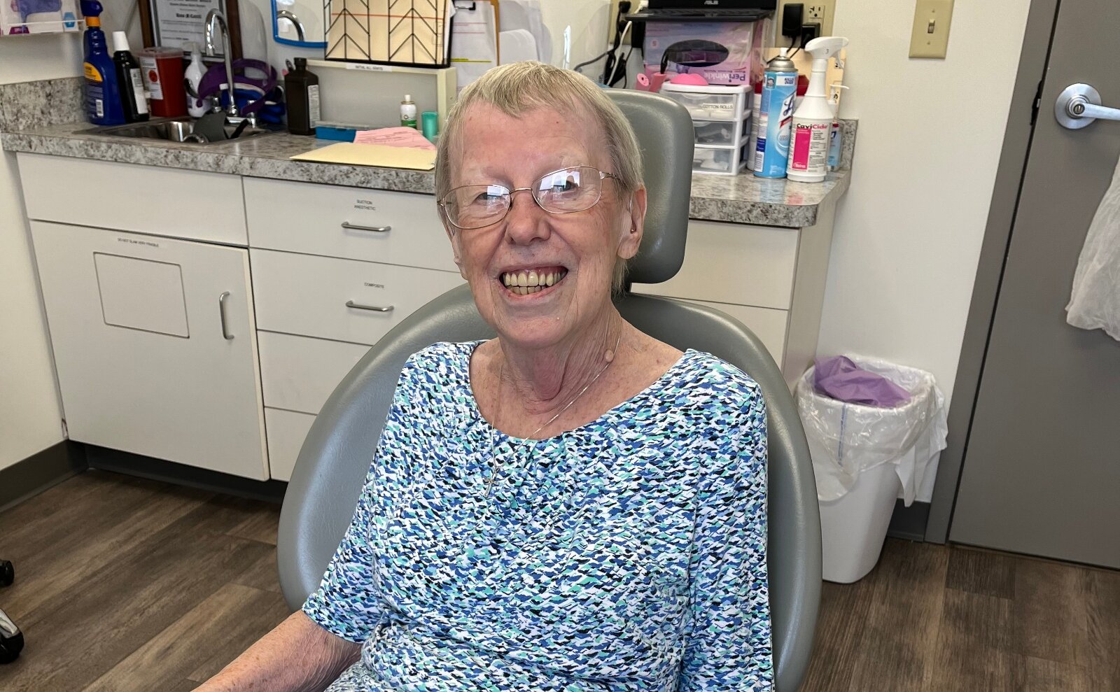 Judy Logan sitting in dental chair at an appointment. 