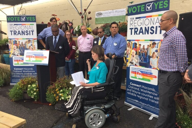 Kristen Milefchik speaks to a crowd at an event promoting a transit millage. 