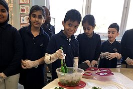 Students toss a healthy kale salad.