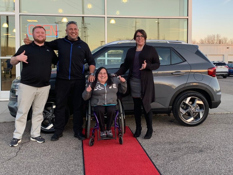Lucia Rios is pictured with the team she worked from start to finish of buying her new car (from left: Jayden Engster, Junior de la Rosa, and Caryn de la Rosa)