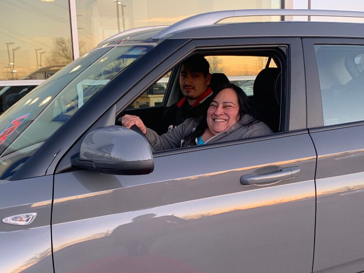 Lucia Rios's first time driving her new car. Her nephew Angelo Mata is in the front seat. He helped her identify how to work with the new technology.