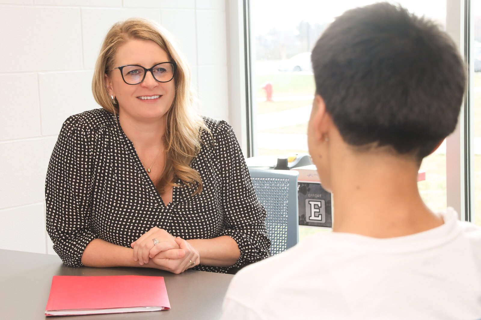 Kristin Graham, principal of Macatawa Bay Middle School, confers with a student.