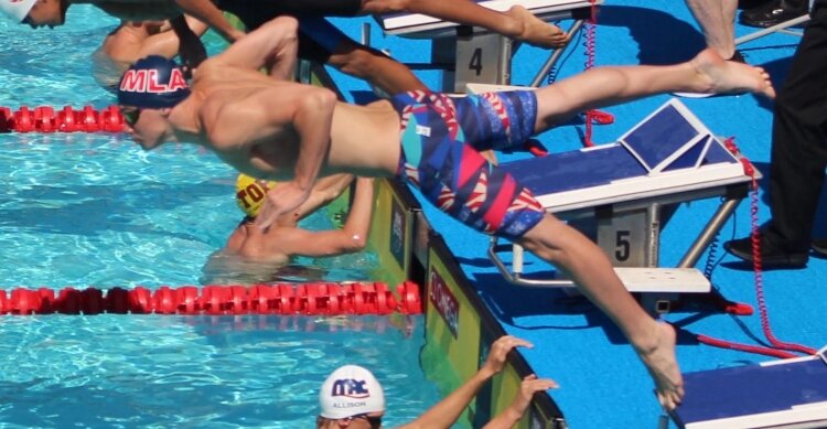 Ian Miskelley dives into the pool during competition.
