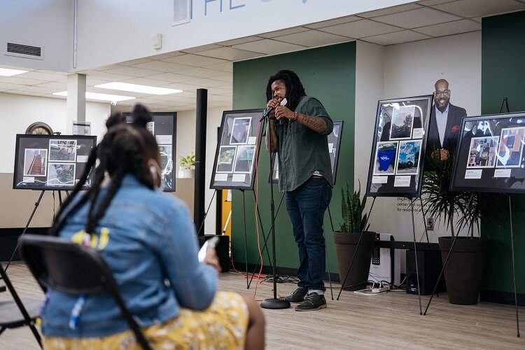 An ECN staff member welcomes visitors to the exhibit.