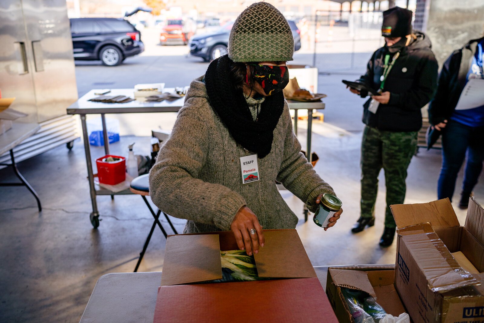 Eastern Market staff prepare food boxes that were ordered online.