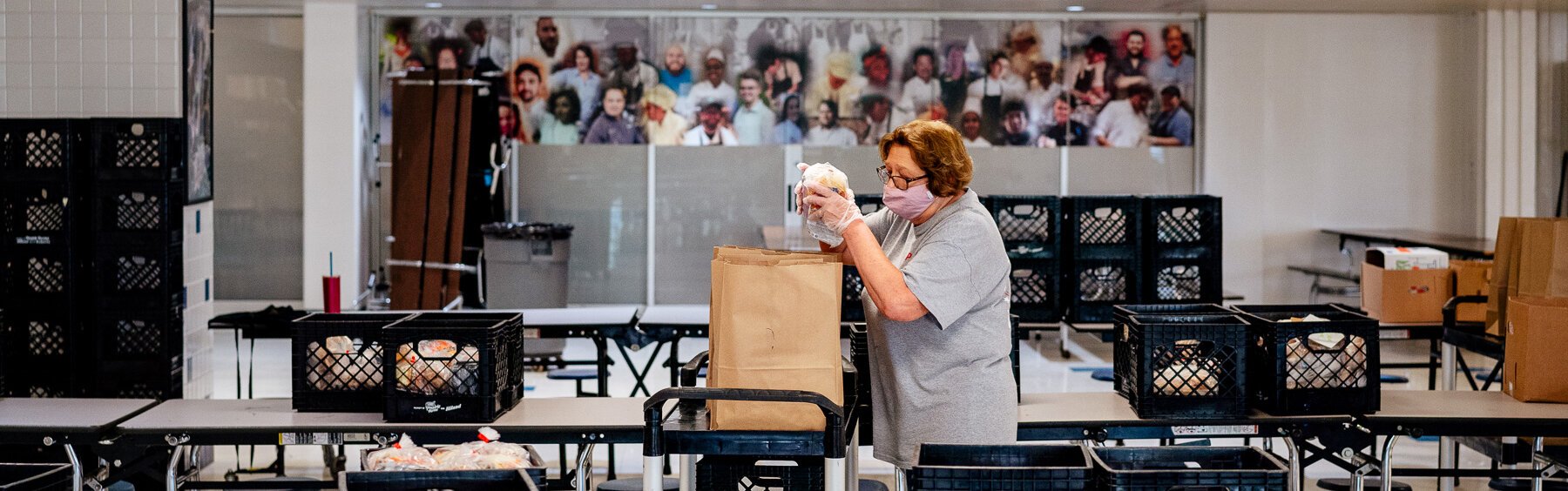 A Plymouth-Canton Community Schools staffer prepares meals for pickup.