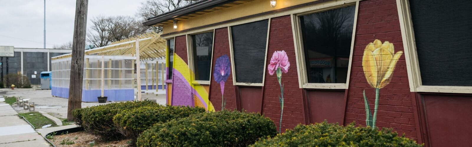 A colorful mural helps frame the mood at the E. Warren Farmers Market.