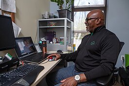 Arbor Circle therapist Marvin Mckenzie simulates a telehealth visit with a colleague.